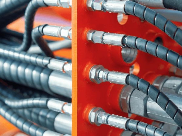 Several DME&JDE hose assemblies with plastic sleeves on the equipment.