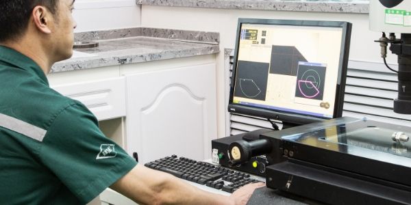 An engineer is drawing the fluid connector.